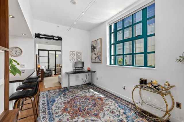 a living room with furniture rug and a window