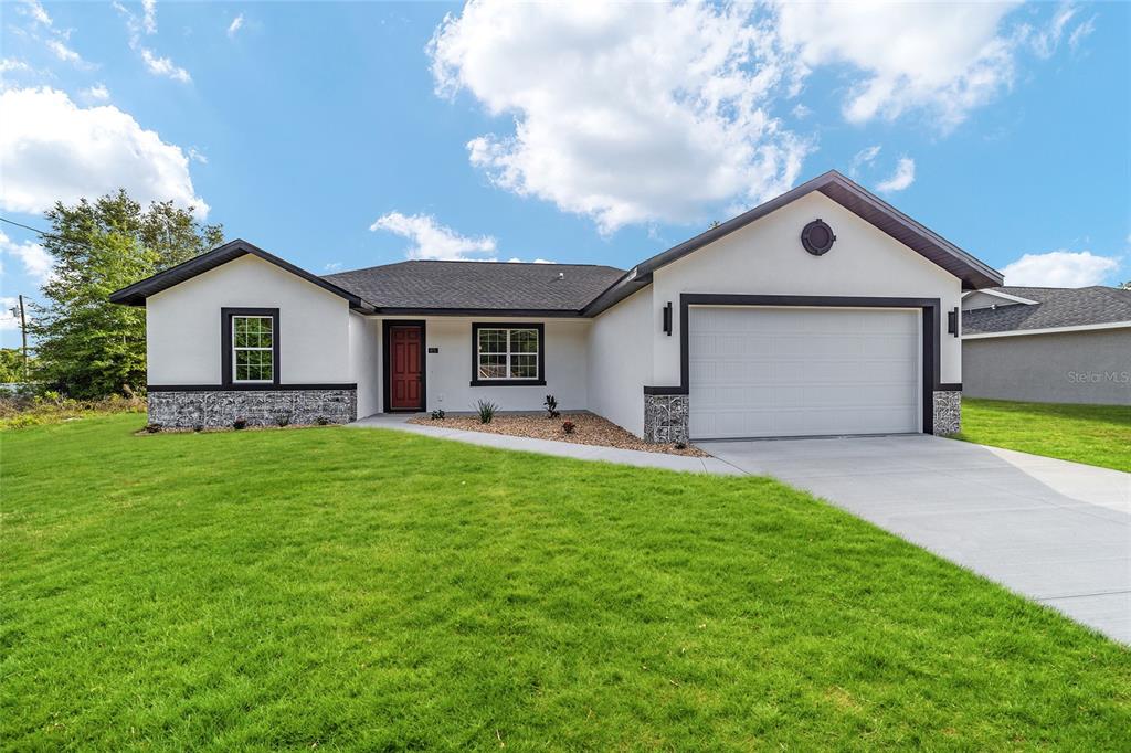 85 Willow Road Ocala, FL 34472 - Photo 1 of 1 a front view of house with yard and green space