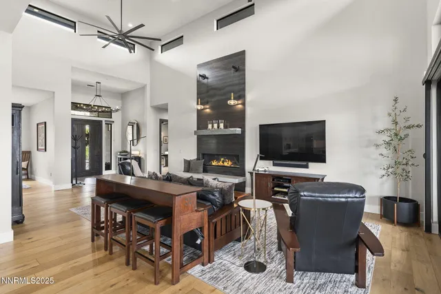 a large kitchen with kitchen island a island a stove a cabinets a sink a dining table and chairs