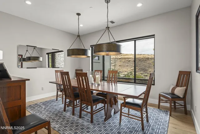a spacious bathroom with a double vanity sink a large mirror and a bathtub