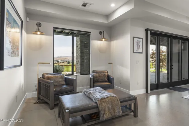 a spacious bedroom with a bed and a large window