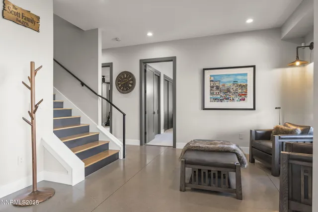 a bathroom with a double vanity sink a toilet a mirror and shower