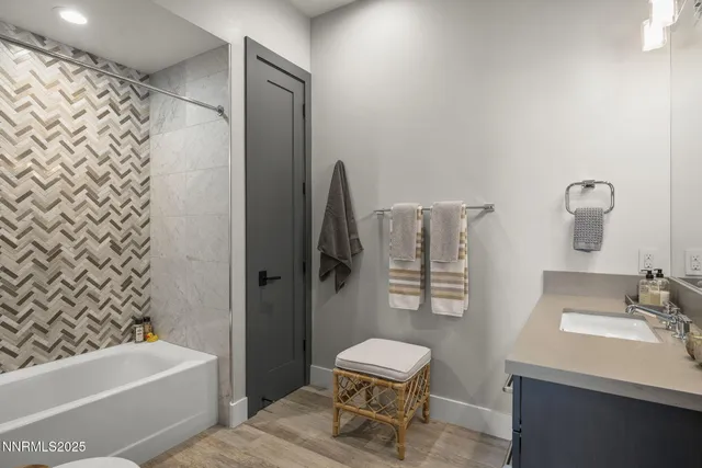 an aerial view of residential houses with outdoor space and ocean view