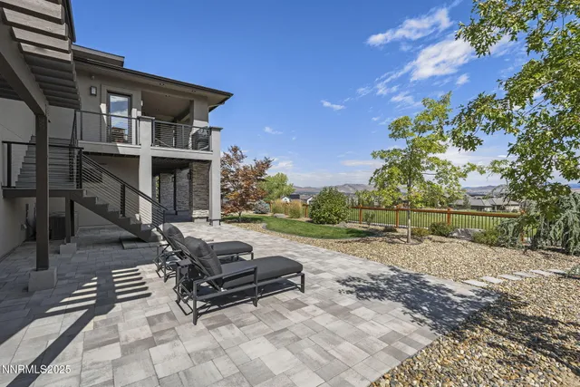 an aerial view of residential houses with outdoor space and trees
