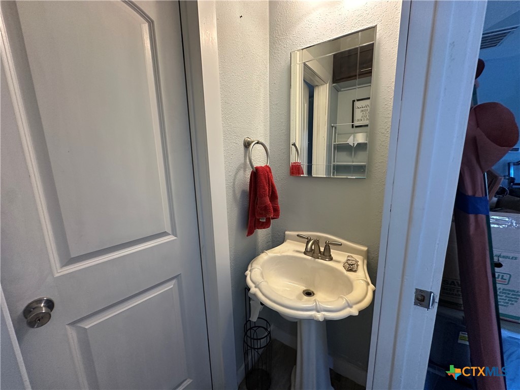 405 North Main Street Copperas Cove, TX 76522 - Photo 6 of 16 a bathroom with a sink and a mirror