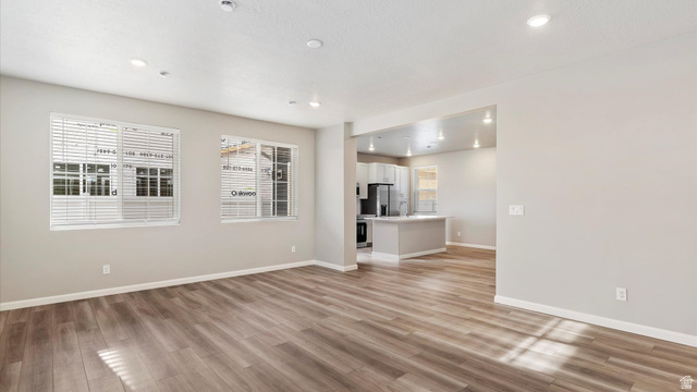82 Provo River Road, Unit 251 Saratoga Springs, UT 84045 - Photo 6 of 32 Open-concept living space featuring wood-finish flooring, recessed lighting, and light-toned wall finishes