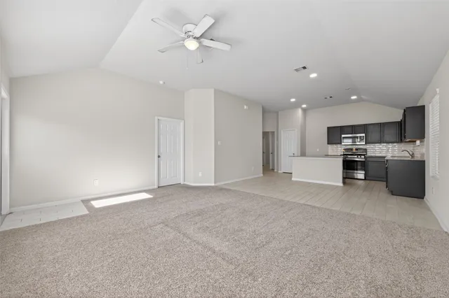 a view of a kitchen with a sink and a stove top oven
