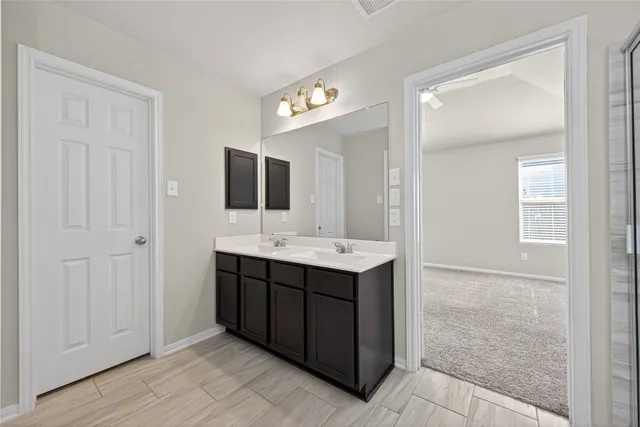 a bathroom with a double vanity sink and mirror