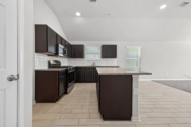 a large kitchen with cabinets