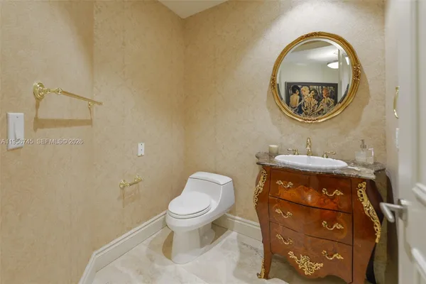 a bathroom with a toilet a sink and a mirror
