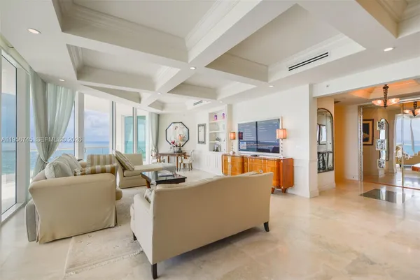 a living room with fireplace furniture and a large window