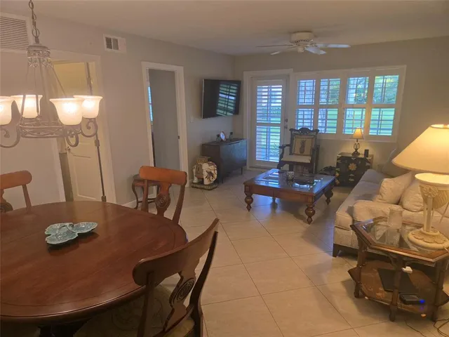 a living room with furniture and chandelier