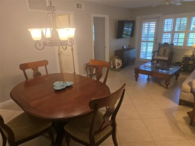 a view of a dining room with furniture and window