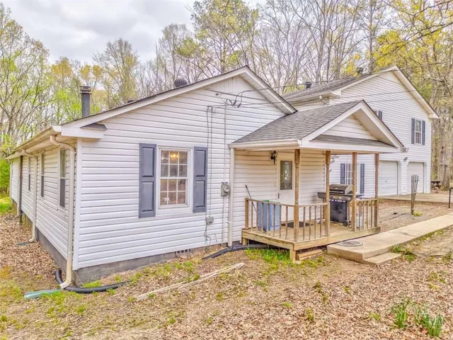a view of a house with a yard and wooden fence