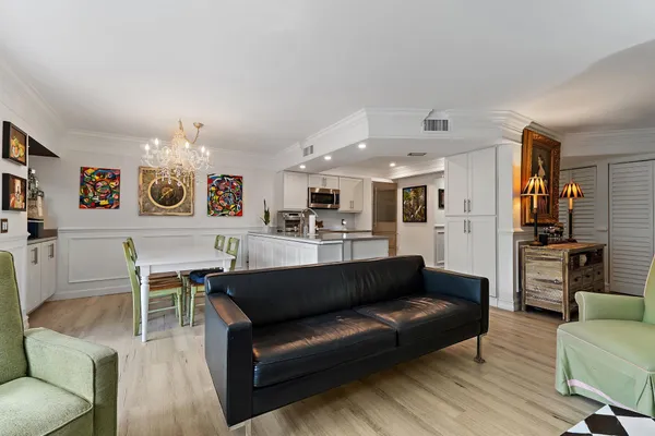 a living room with furniture and kitchen view