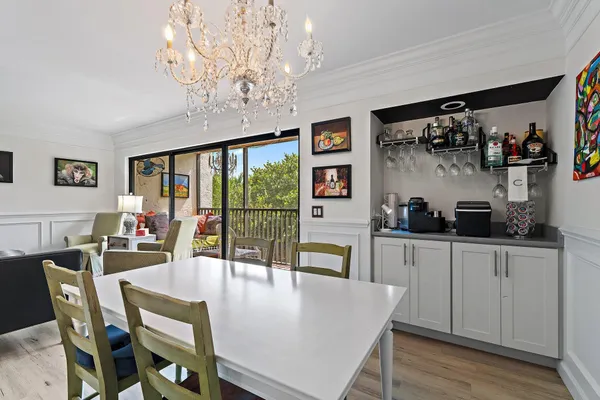a view of a dining room with furniture and chandelier
