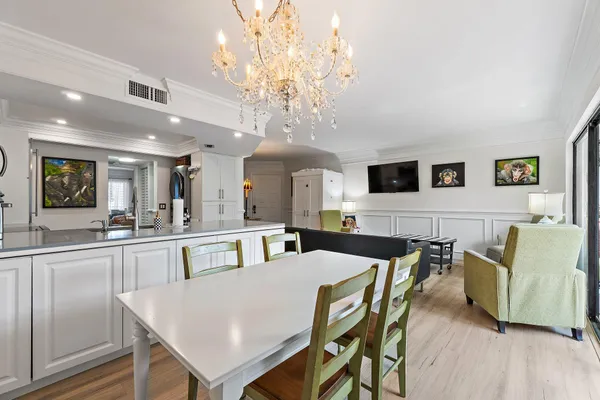 a view of a dining room with furniture and a chandelier