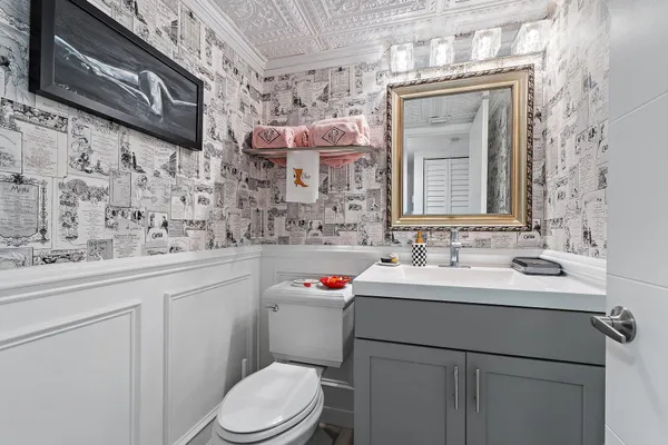 a bathroom with a sink toilet and mirror