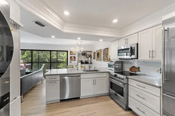 a kitchen with stainless steel appliances kitchen island granite countertop a sink and cabinets