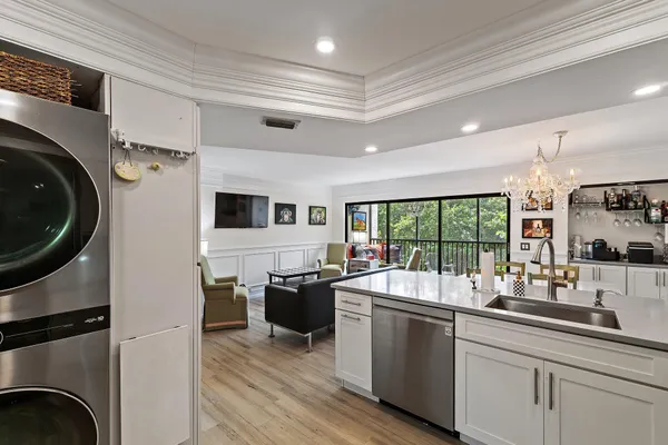 a kitchen with sink refrigerator and large window
