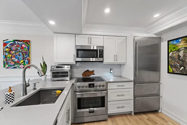 a kitchen with appliances cabinets and a sink