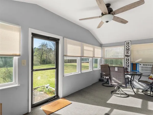 a work room with glass windows table and chairs