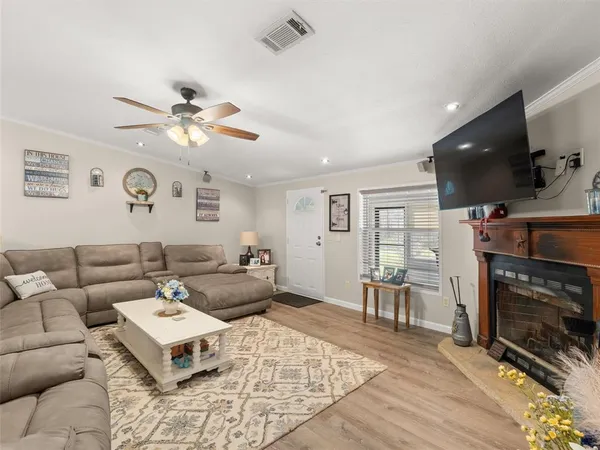 a living room with furniture a fireplace and a flat screen tv