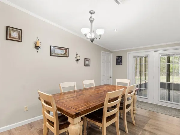 a view of a dining room with furniture large window and wooden floor