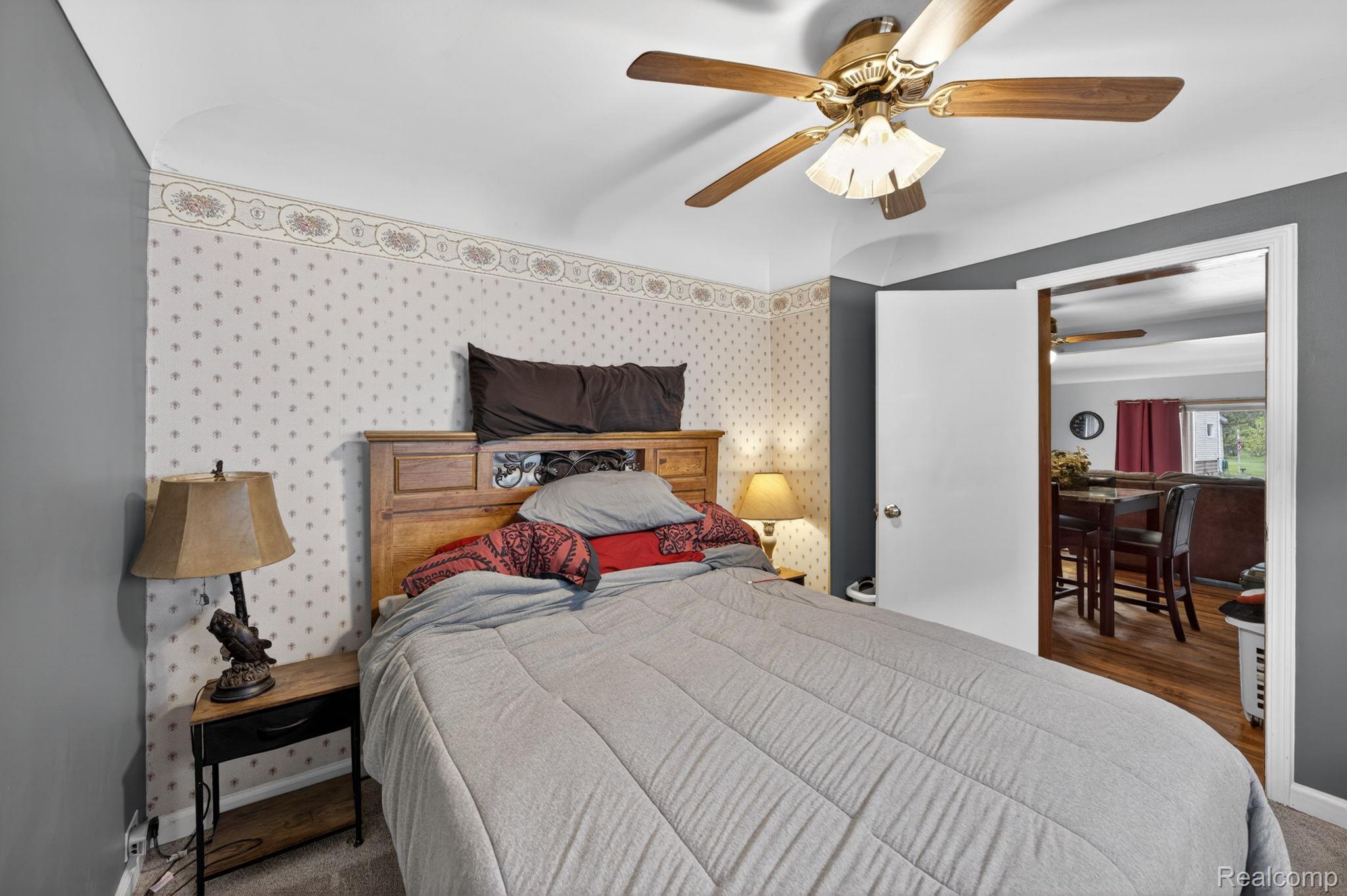 304 West Ridge Street Owosso, MI 48867 - Photo 16 of 45 Bedroom featuring ceiling fan, carpet, and wallpapered walls