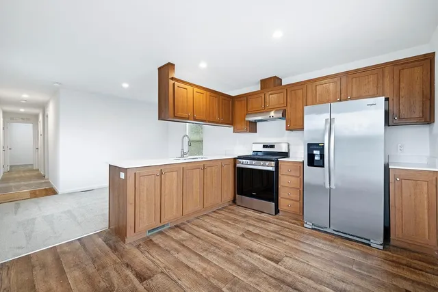 a kitchen with granite countertop a refrigerator and a sink