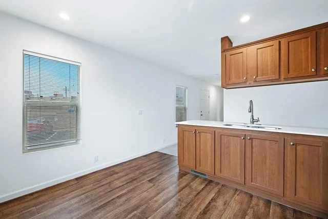 a view of cabinets a wooden floor and a window