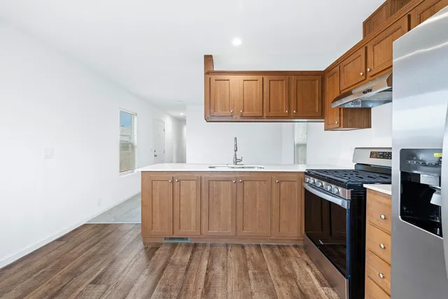 a kitchen with granite countertop a stove and cabinets