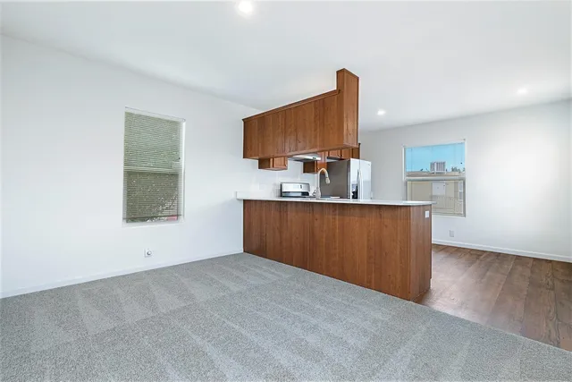a view of a kitchen with a sink and a mirror