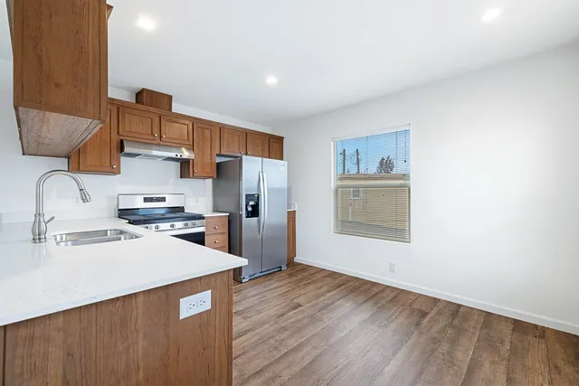 a kitchen with stainless steel appliances a refrigerator and a sink