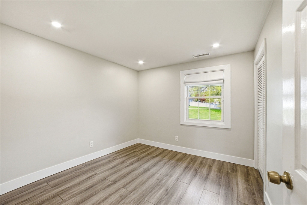 157 Errol Road Brockton, MA 02302 - Photo 26 of 34 an empty room with wooden floor and windows
