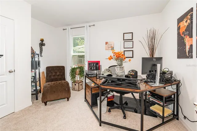 a view of a workspace with furniture and a flat screen tv