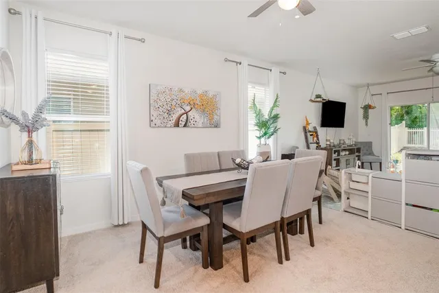 a dining room with furniture and window