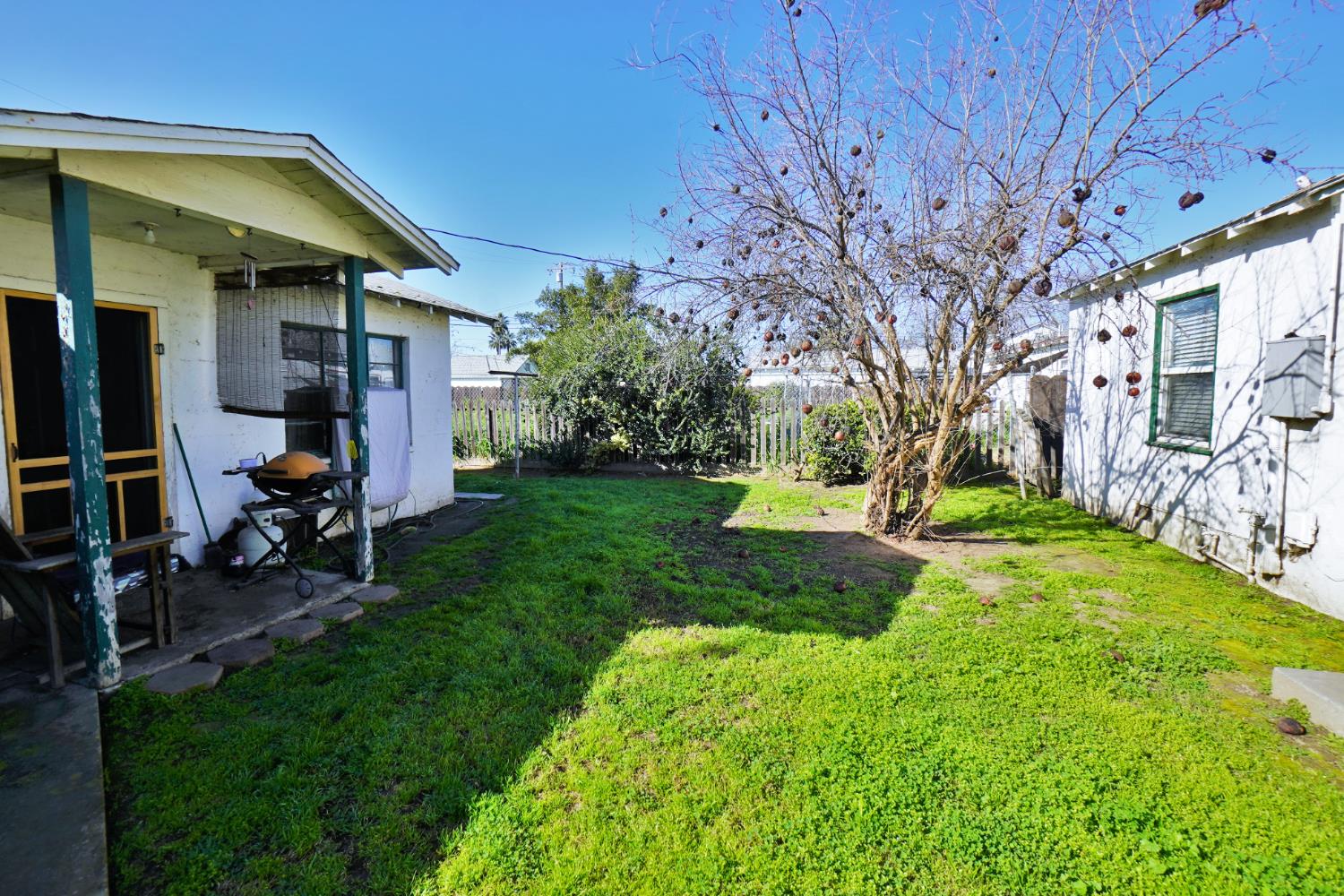 605 East Myrtle Street Hanford, CA 93230 - Photo 11 of 17 a view of a patio with table and chairs under an umbrella