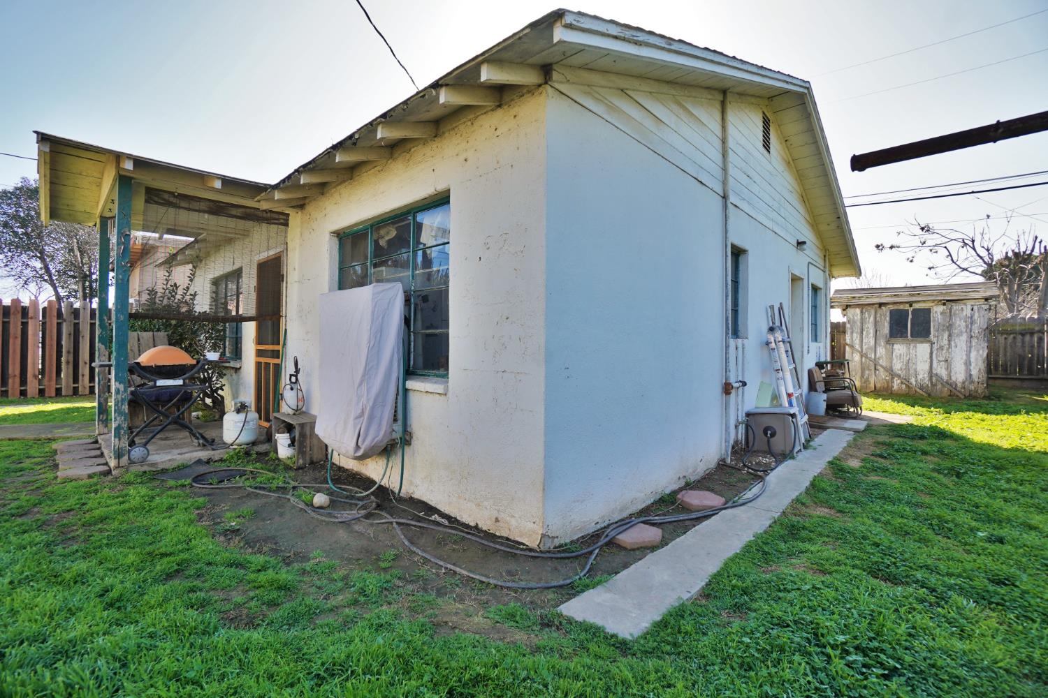 605 East Myrtle Street Hanford, CA 93230 - Photo 13 of 17 a view of an house with backyard space and a garden
