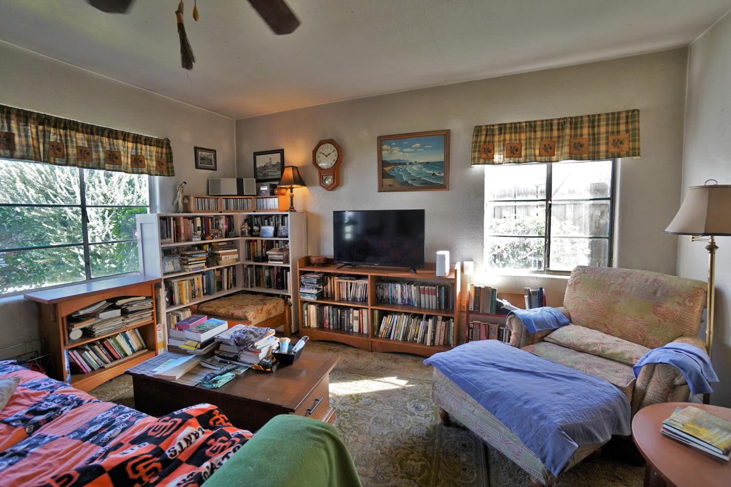605 East Myrtle Street Hanford, CA 93230 - Photo 15 of 17 a living room with furniture a flat screen tv and a floor to ceiling window