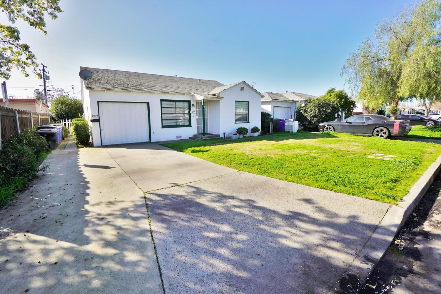 605 East Myrtle Street Hanford, CA 93230 - Photo 2 of 17 a front view of a house with a yard and garage