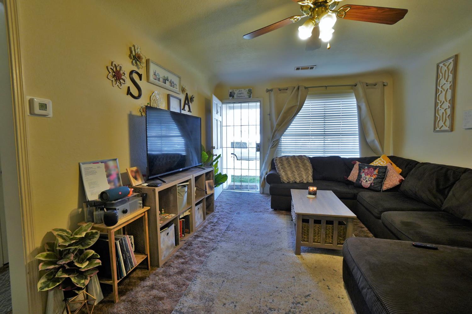 605 East Myrtle Street Hanford, CA 93230 - Photo 3 of 17 a living room with furniture and a flat screen tv