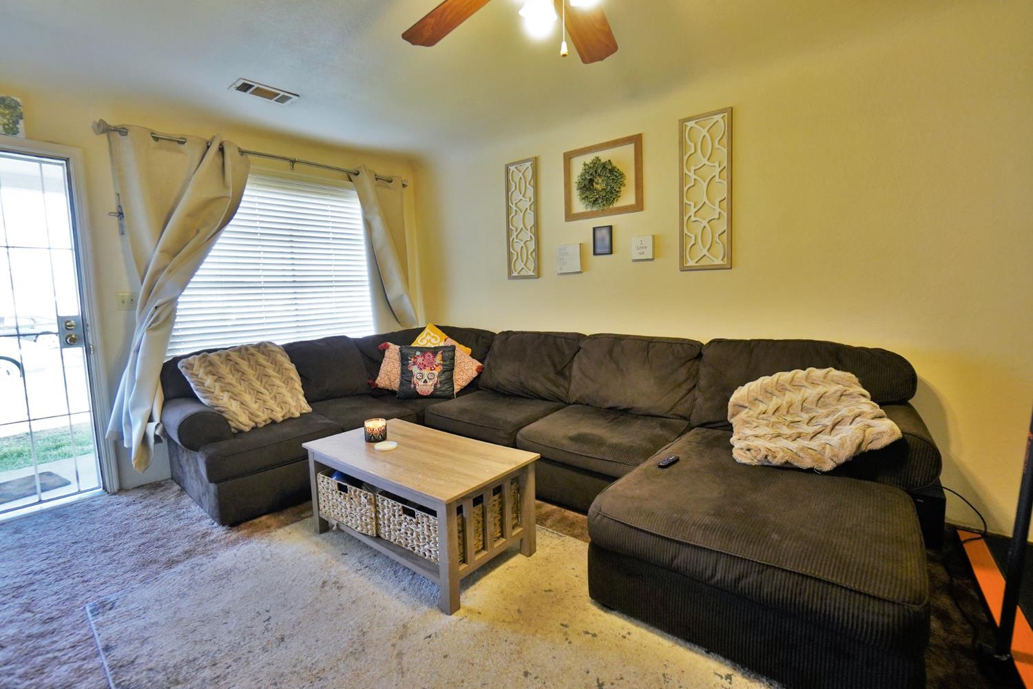 605 East Myrtle Street Hanford, CA 93230 - Photo 4 of 17 a living room with a couch and a chandelier