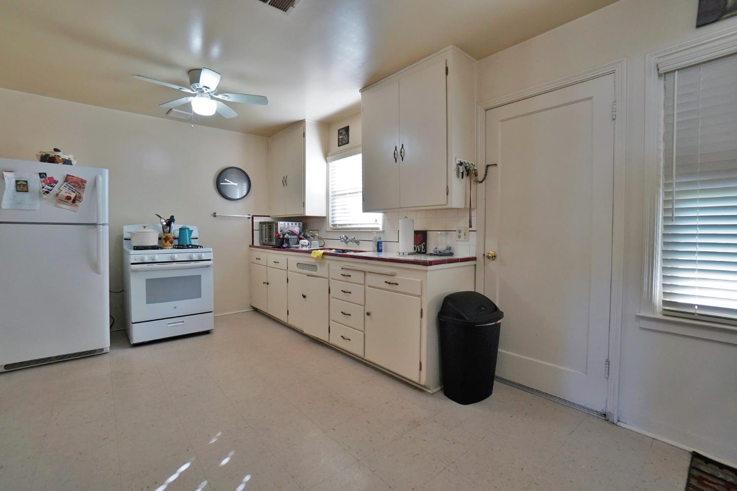 605 East Myrtle Street Hanford, CA 93230 - Photo 7 of 17 a kitchen with a sink cabinets and window