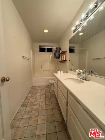 a spacious bathroom with a sink a mirror and a shower