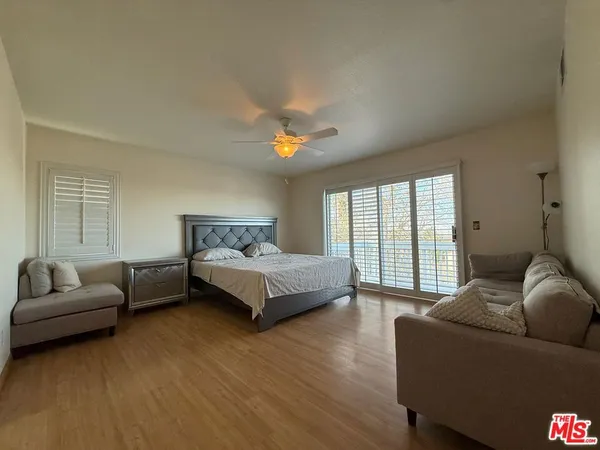 a spacious bedroom with a bed and a couch