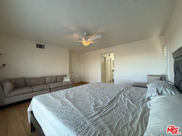a bedroom with a bed and a couch