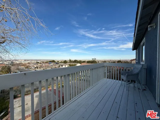 a view of roof deck with wooden floor and fence