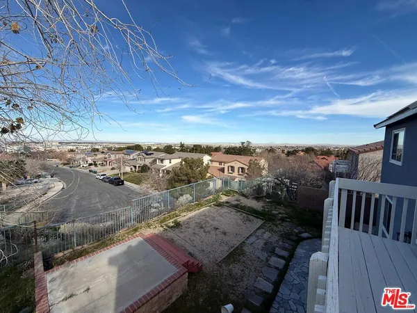 a view of a terrace with wooden floor and city view