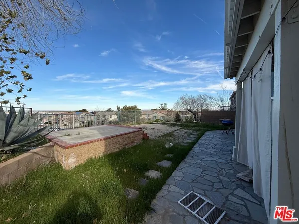 a view of a backyard of the house